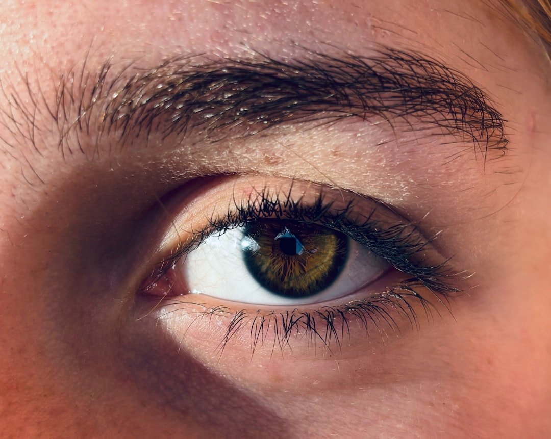 Close-up of eyebrow tinting process showing pigment application